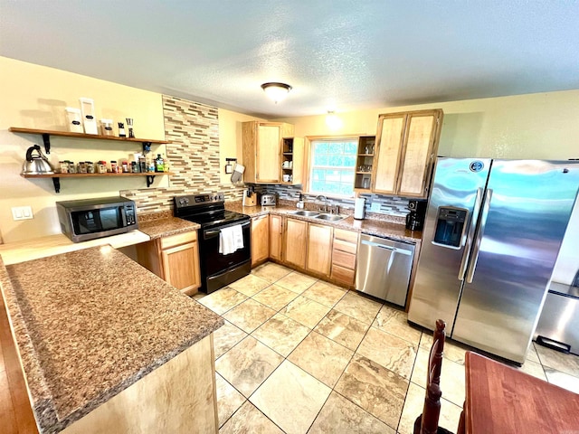 kitchen featuring appliances with stainless steel finishes, a textured ceiling, sink, backsplash, and stone counters