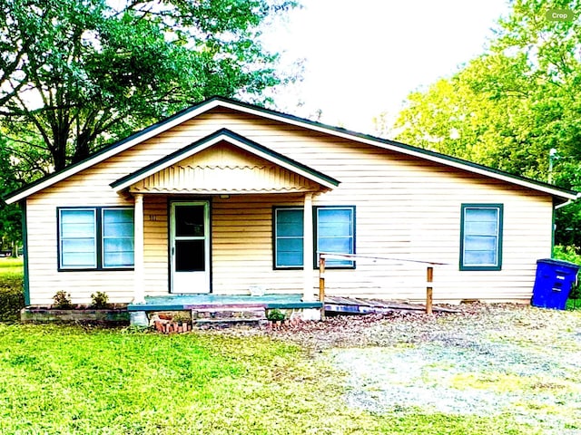 bungalow-style home featuring a front yard