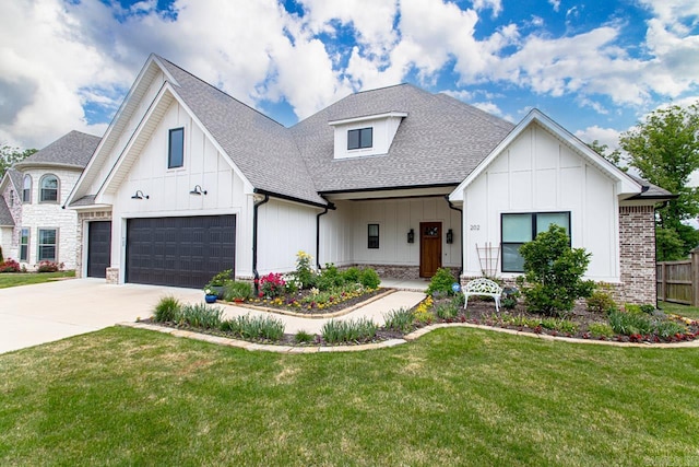 modern farmhouse featuring a garage and a front lawn