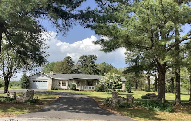 ranch-style home with a garage and a front yard