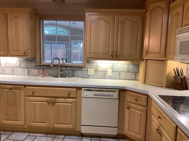 kitchen featuring backsplash, light tile floors, white appliances, and sink