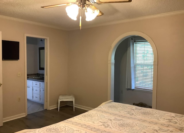 unfurnished bedroom featuring dark tile floors, a textured ceiling, ceiling fan, and sink