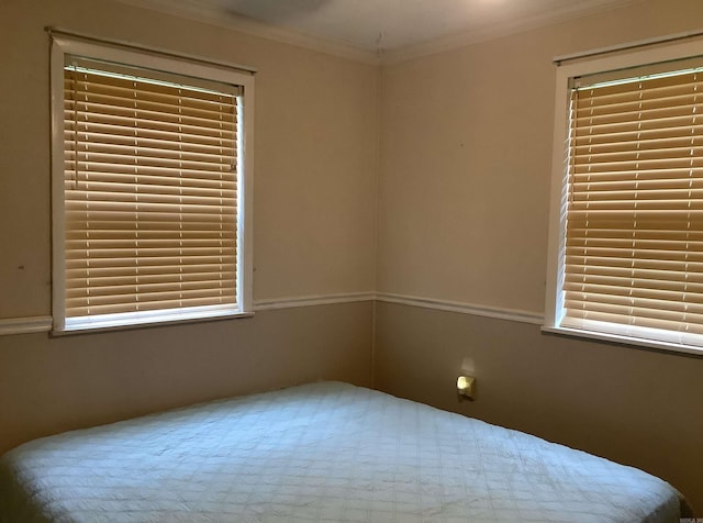 unfurnished bedroom featuring ornamental molding