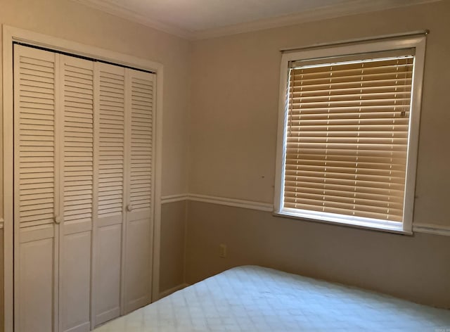 unfurnished bedroom featuring a closet and crown molding