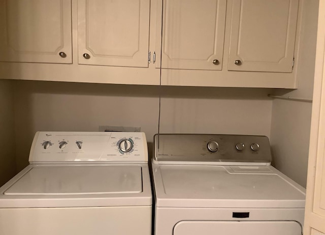 washroom with cabinets and independent washer and dryer