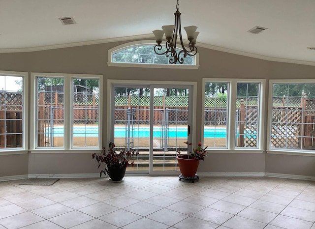 unfurnished sunroom featuring plenty of natural light, an inviting chandelier, and lofted ceiling