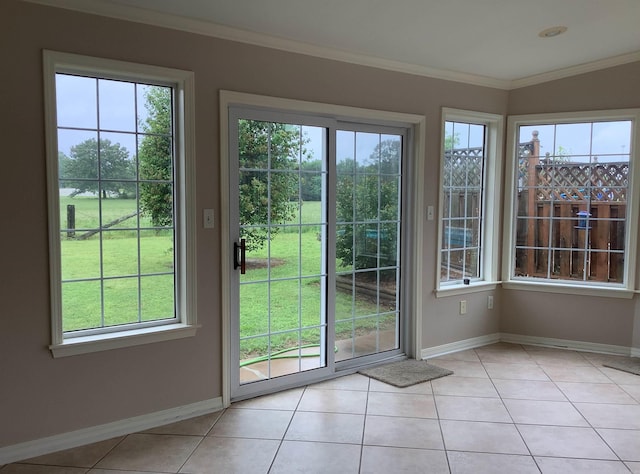 entryway with ornamental molding and light tile floors