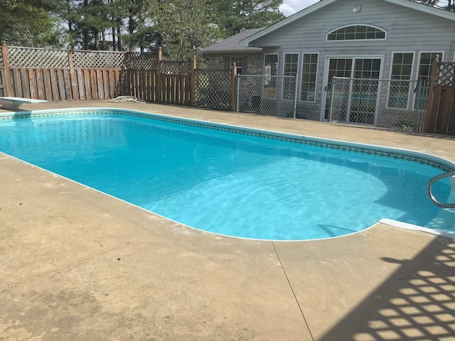 view of pool featuring a diving board