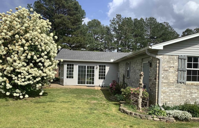 rear view of property with a yard