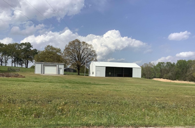 view of yard with a garage and an outdoor structure