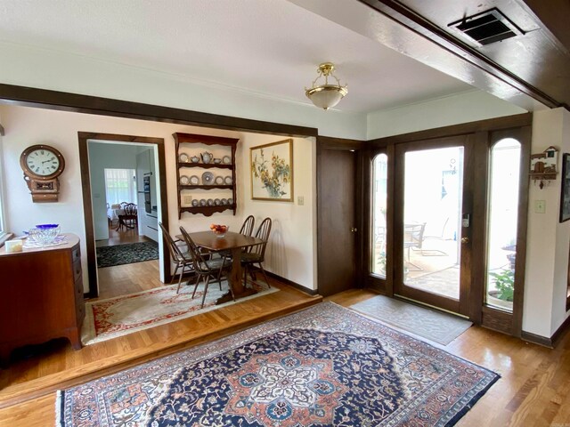 foyer entrance featuring wood-type flooring and plenty of natural light