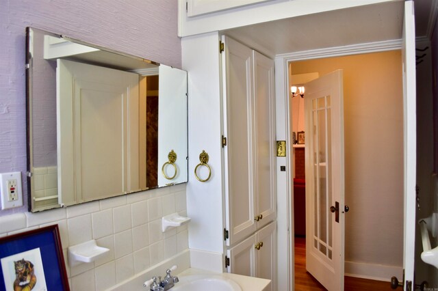 bathroom with backsplash and wood-type flooring