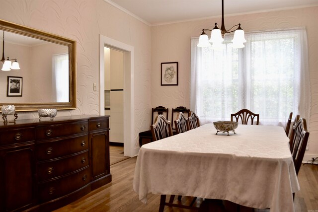 dining area with a notable chandelier and light hardwood / wood-style flooring