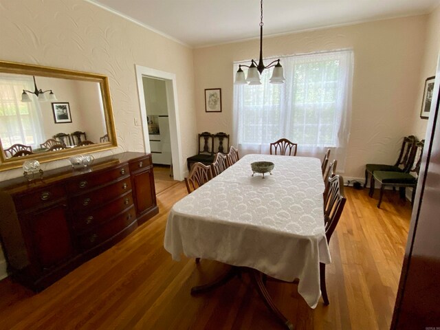 dining space featuring an inviting chandelier and wood-type flooring