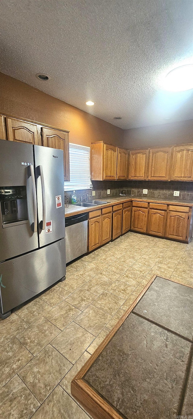 kitchen featuring tasteful backsplash, light tile floors, and stainless steel appliances