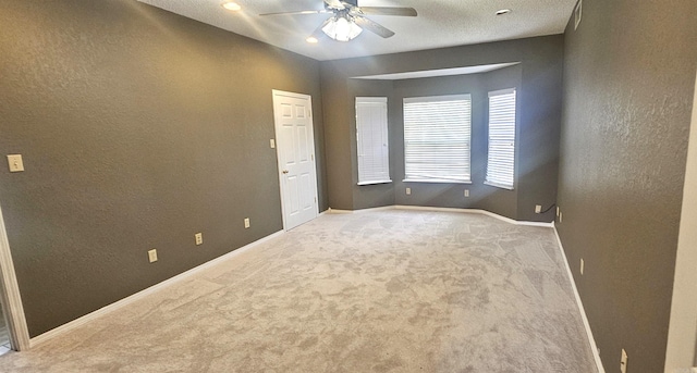 unfurnished room featuring ceiling fan, carpet flooring, and a textured ceiling