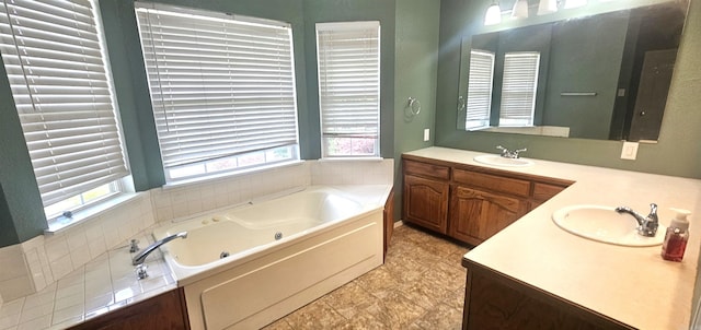 bathroom with a healthy amount of sunlight, vanity, a bathtub, and tile flooring