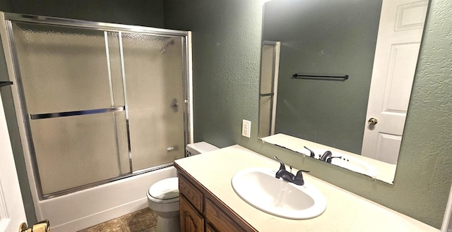 full bathroom featuring shower / bath combination with glass door, vanity, tile floors, and toilet