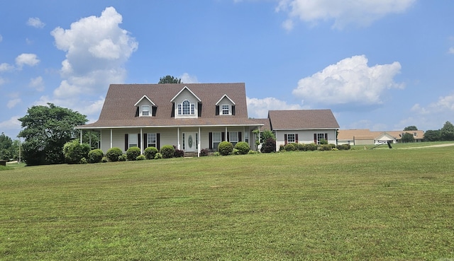 new england style home with covered porch and a front lawn