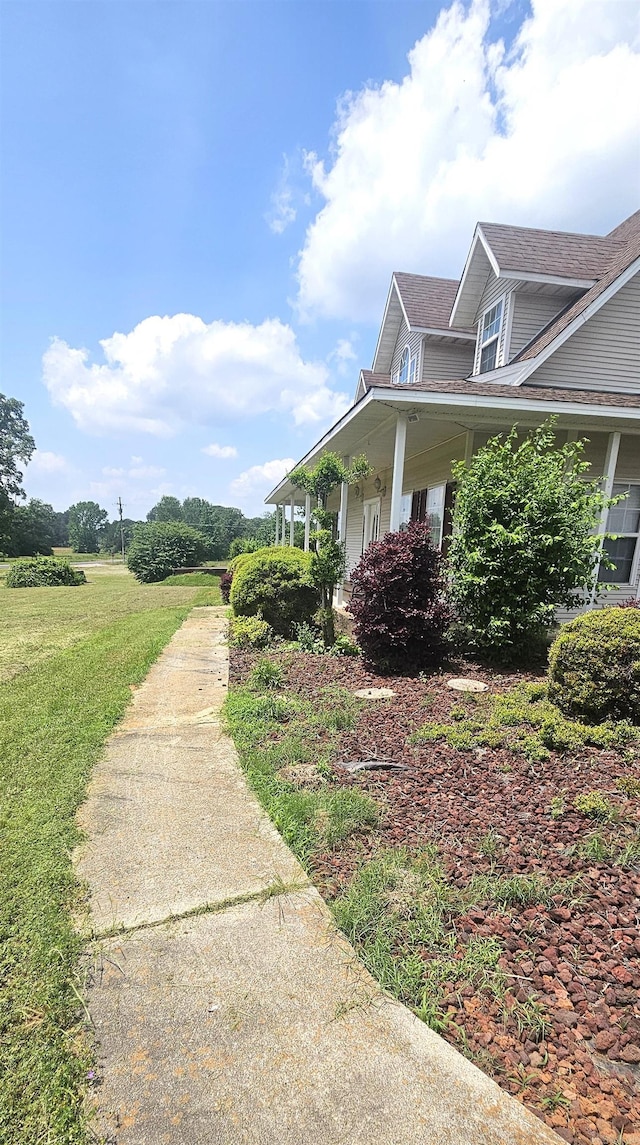 view of side of property with covered porch