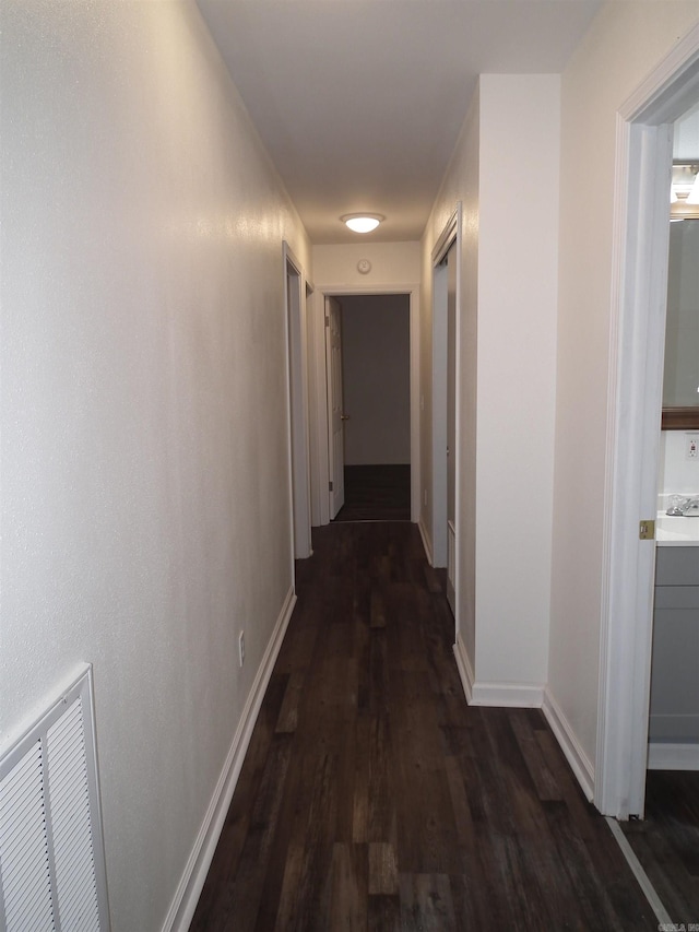 corridor with hardwood / wood-style floors