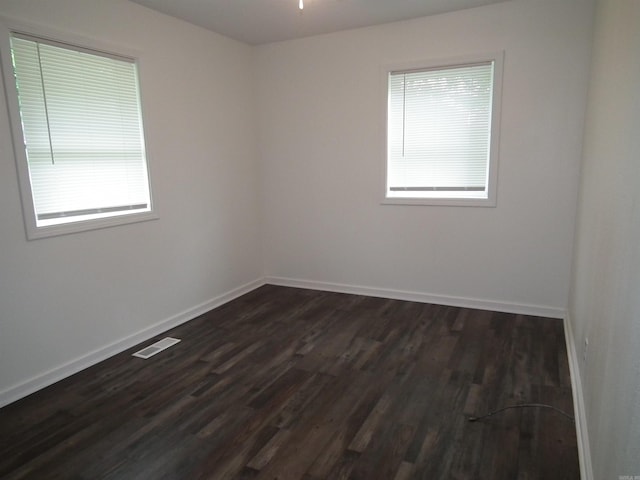 unfurnished room featuring hardwood / wood-style floors and a wealth of natural light