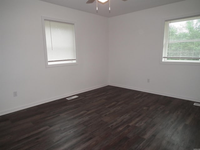 empty room with ceiling fan and dark hardwood / wood-style floors