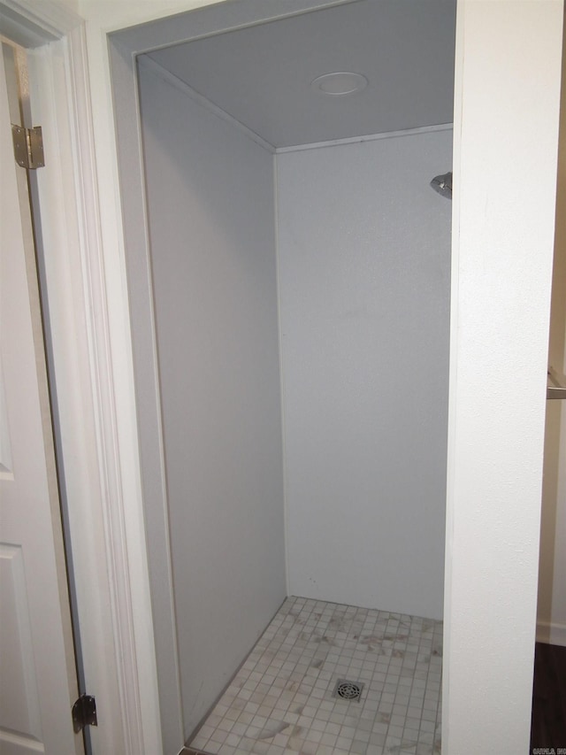 bathroom with walk in shower and tile floors