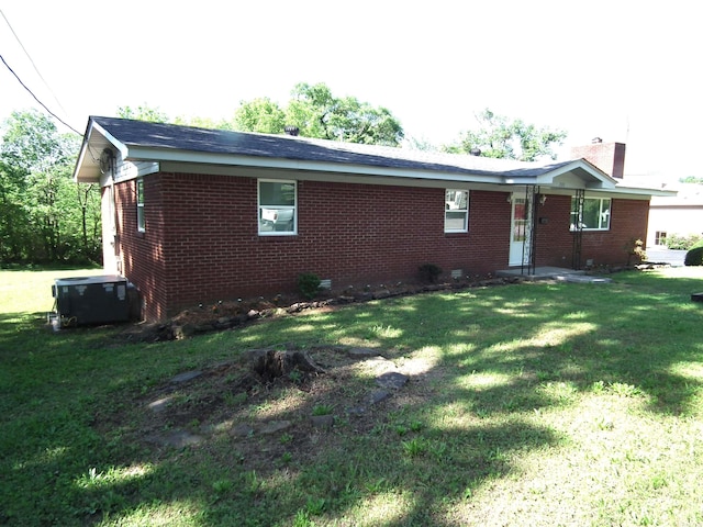 view of home's exterior featuring a yard and central air condition unit