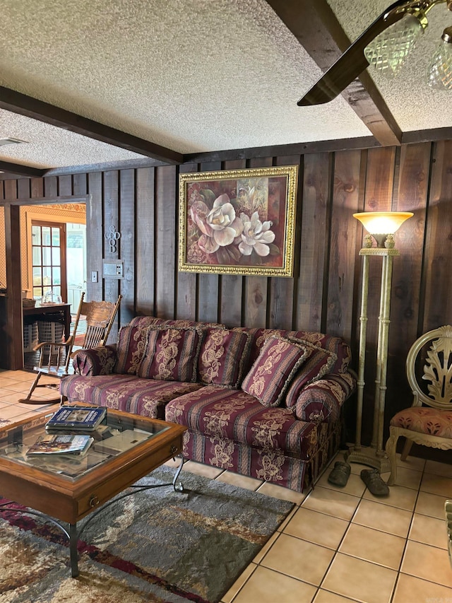 living room with wooden walls, tile floors, and a textured ceiling