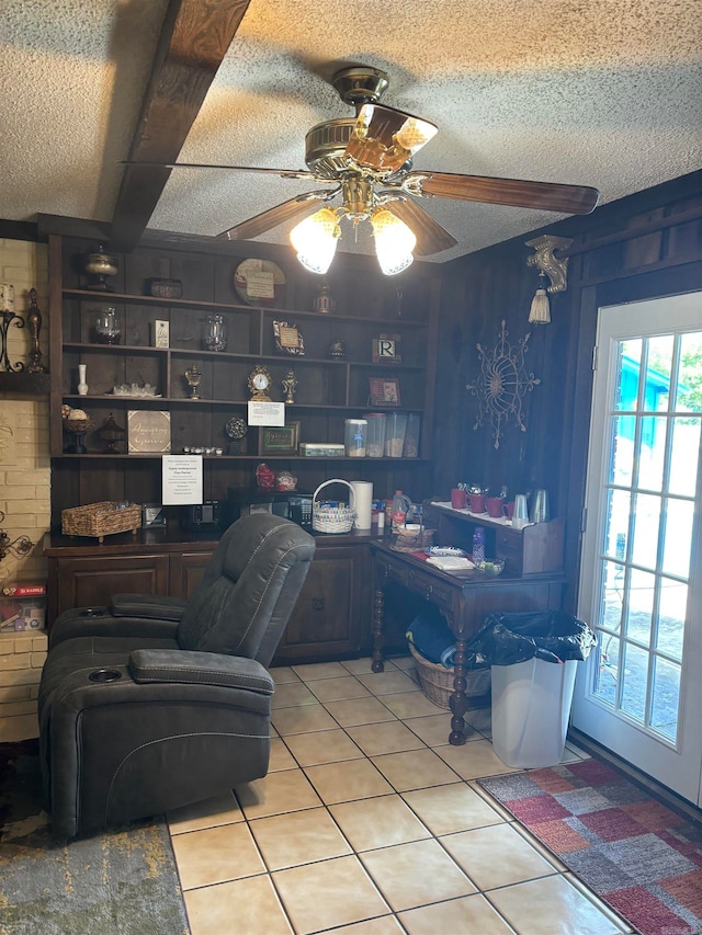 office featuring ceiling fan, a textured ceiling, and light tile flooring