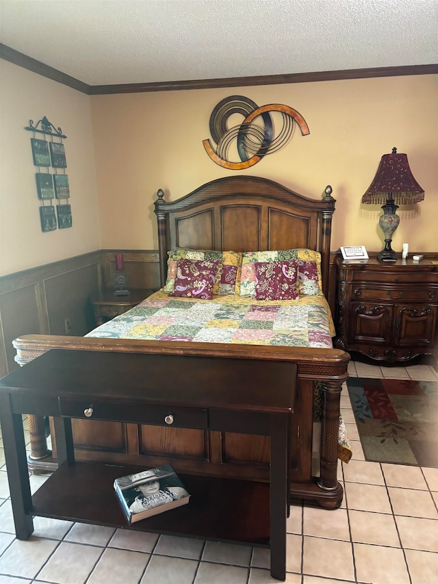 bedroom with a textured ceiling, light tile flooring, and ornamental molding