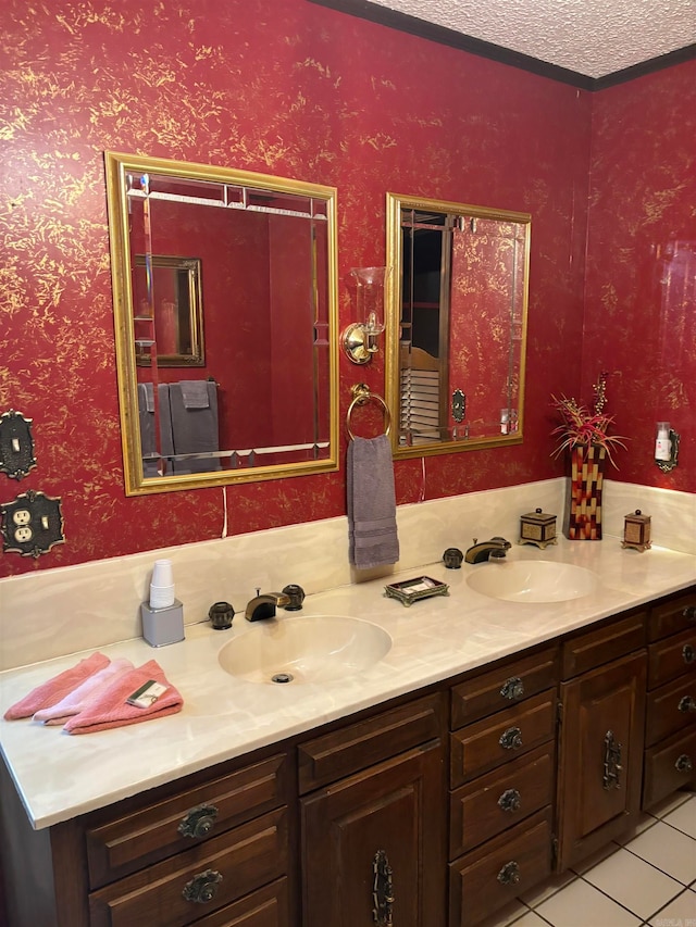 bathroom with dual sinks, oversized vanity, tile floors, and a textured ceiling