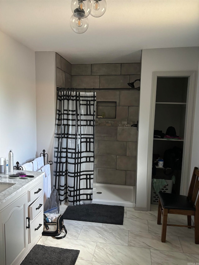 bathroom with tile flooring, a shower, vanity, and built in shelves