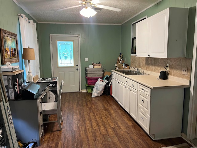 kitchen featuring white cabinets, crown molding, dark hardwood / wood-style floors, ceiling fan, and a textured ceiling