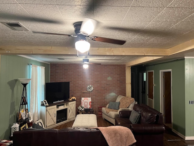 living room with brick wall and ceiling fan