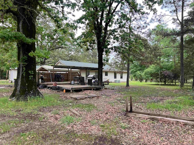 view of yard featuring a wooden deck and a gazebo