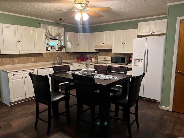 kitchen with white appliances, white cabinets, dark hardwood / wood-style flooring, sink, and ceiling fan