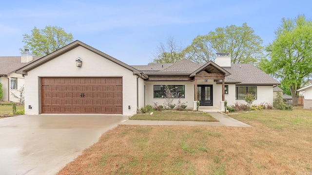 ranch-style house featuring a garage and a front yard