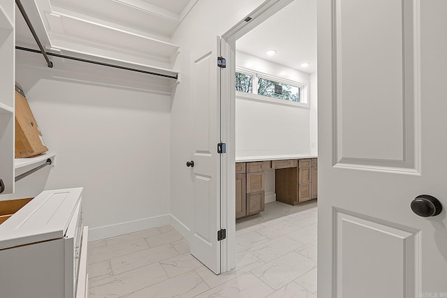 spacious closet with light tile patterned flooring and built in desk