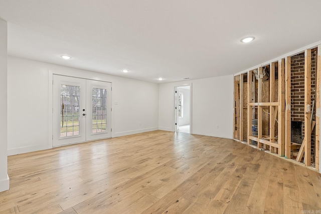 empty room with french doors and light hardwood / wood-style floors