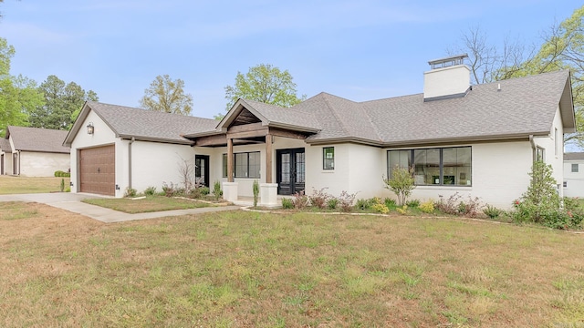 view of front of house featuring a garage and a front yard