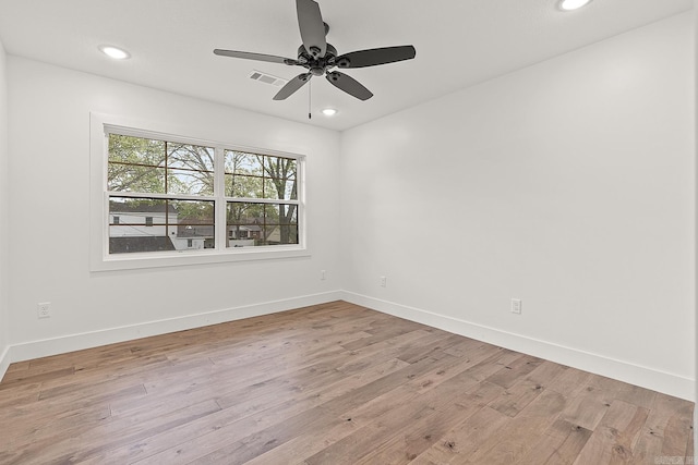 spare room featuring ceiling fan and light hardwood / wood-style flooring