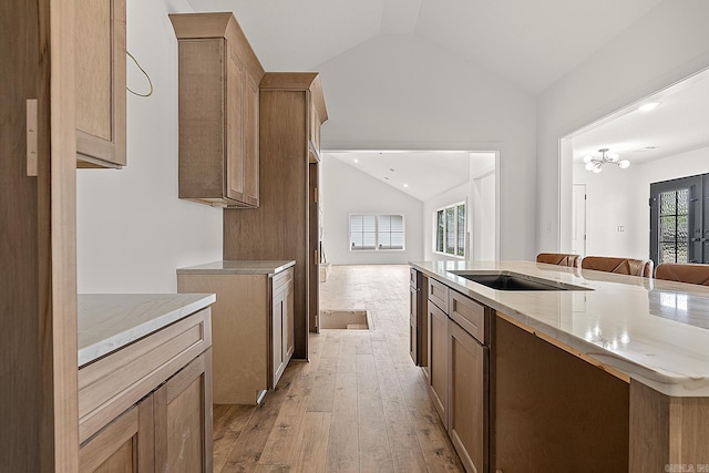 kitchen featuring vaulted ceiling and light wood-type flooring