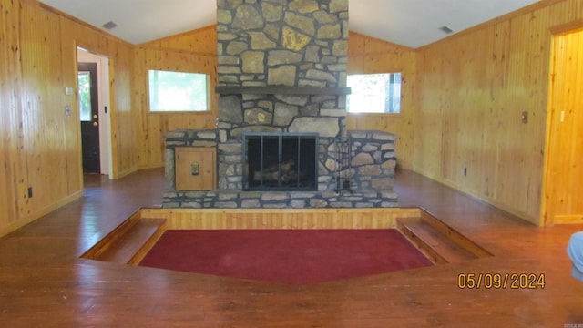 living room featuring hardwood / wood-style floors, lofted ceiling, a fireplace, and plenty of natural light