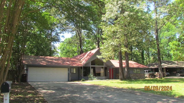 ranch-style home with a garage and a front yard