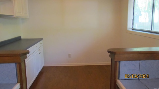 kitchen featuring white cabinets and dark hardwood / wood-style flooring