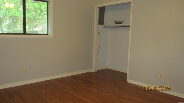 unfurnished bedroom with dark hardwood / wood-style floors