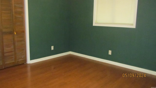 interior space with dark wood-type flooring and a closet