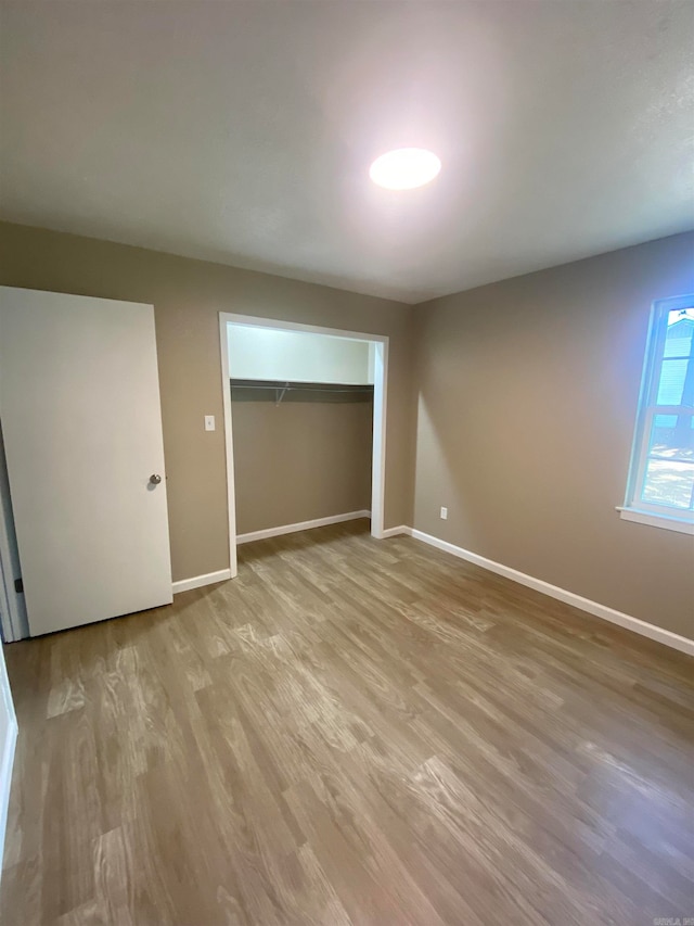 empty room with hardwood / wood-style flooring